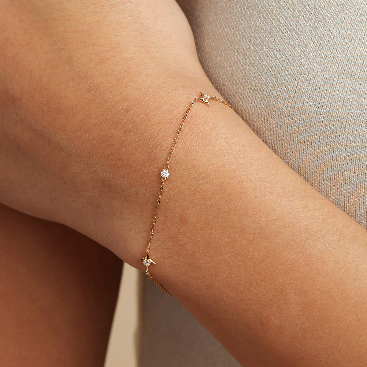 Astrid & Miyu Cosmic Star Charm Bracelet in Gold worn on the wrist
